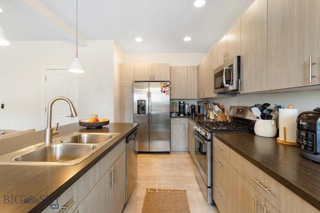 1307 Grover Ln Unit B, Belgrade, MT 59714 - kitchen featuring pendant lighting, a sink, light brown cabinets, stainless steel appliances, and recessed lighting
