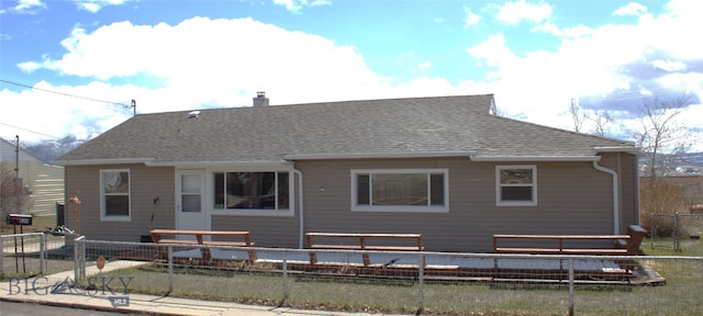 820 Lexington Ave, Butte, MT 59701 - back of property with a fenced backyard, a chimney, and a shingled roof