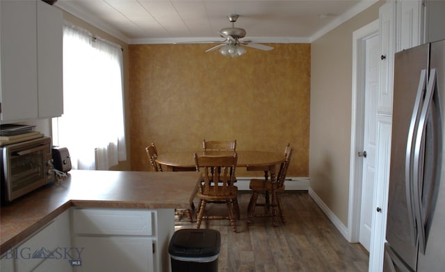 820 Lexington Ave, Butte, MT 59701 - dining room with ceiling fan, baseboard heating, wood finished floors, a toaster, and baseboards