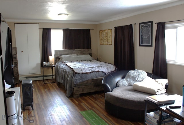 820 Lexington Ave, Butte, MT 59701 - bedroom with multiple windows, a baseboard heating unit, and hardwood / wood-style flooring