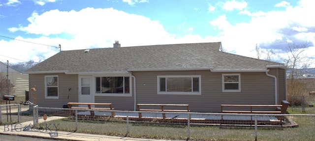 820 Lexington Ave, Butte, MT 59701 - back of house with a fenced backyard, a chimney, and roof with shingles