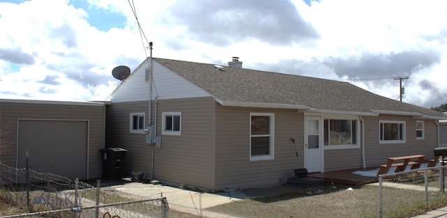 820 Lexington Ave, Butte, MT 59701 - rear view of house featuring an attached garage, a shingled roof, fence, and a chimney