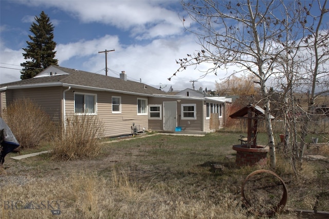 820 Lexington Ave, Butte, MT 59701 - back of house featuring roof with shingles, a yard, and a chimney