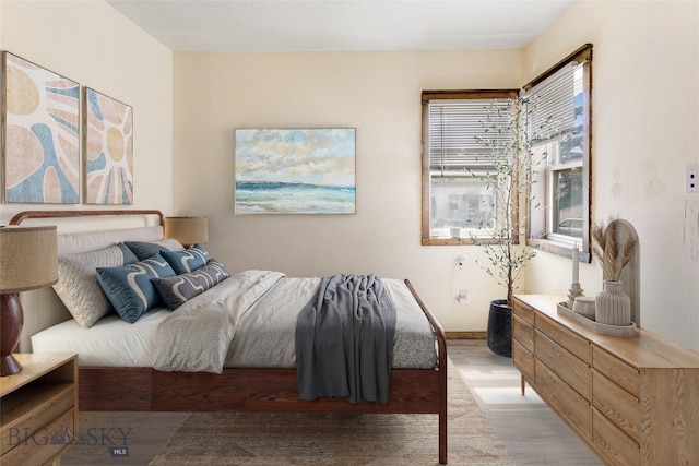 bedroom featuring baseboards and light wood-style flooring