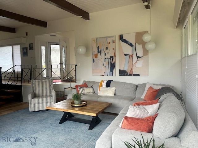 living area with beamed ceiling