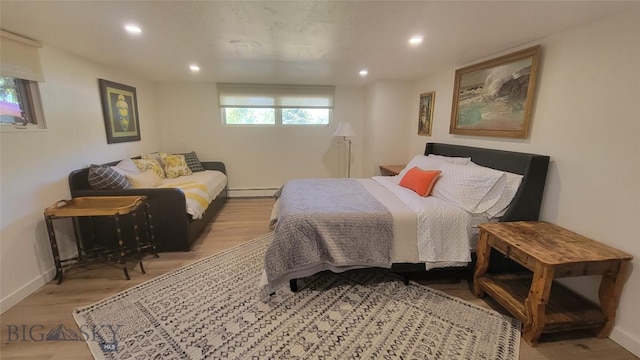 bedroom featuring recessed lighting, baseboards, baseboard heating, and wood finished floors