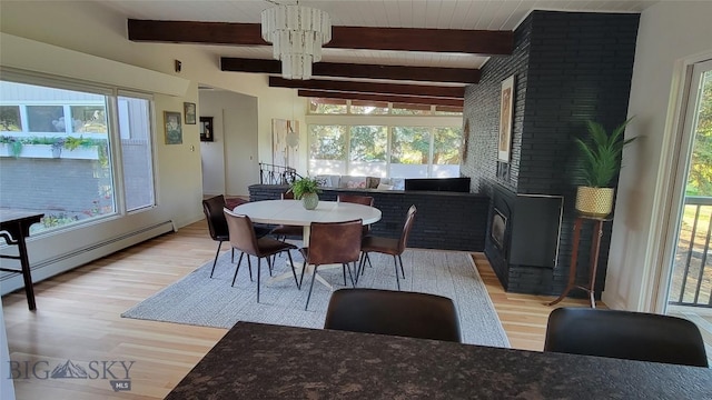 dining room with a baseboard heating unit, light wood-style flooring, beam ceiling, and a chandelier