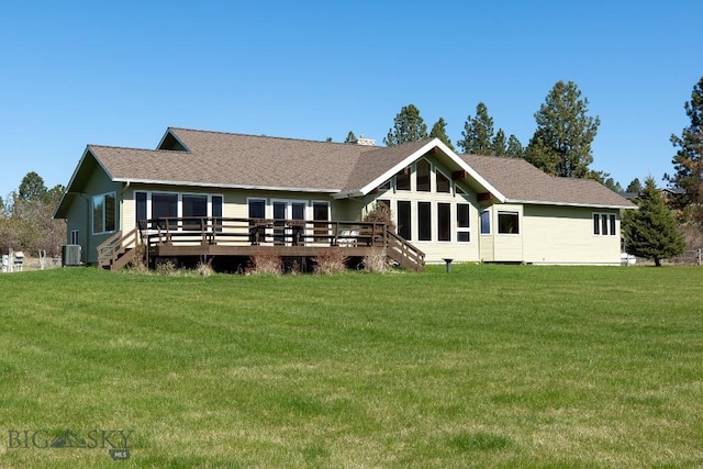 back of house featuring a lawn, a wooden deck, and central air condition unit