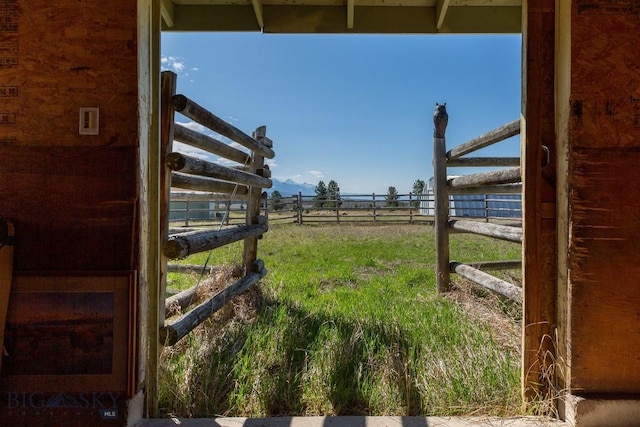 view of yard featuring an exterior structure and a rural view