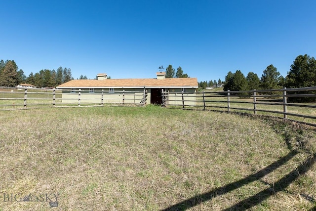 view of yard with a rural view and fence