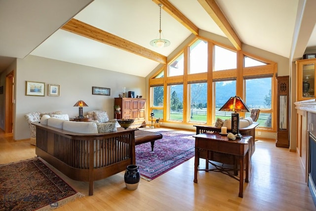 living area with light wood finished floors, high vaulted ceiling, beam ceiling, and a fireplace