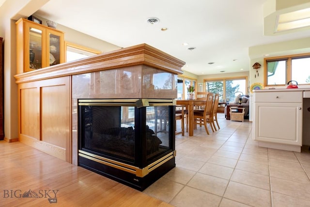 details featuring recessed lighting, visible vents, and a premium fireplace