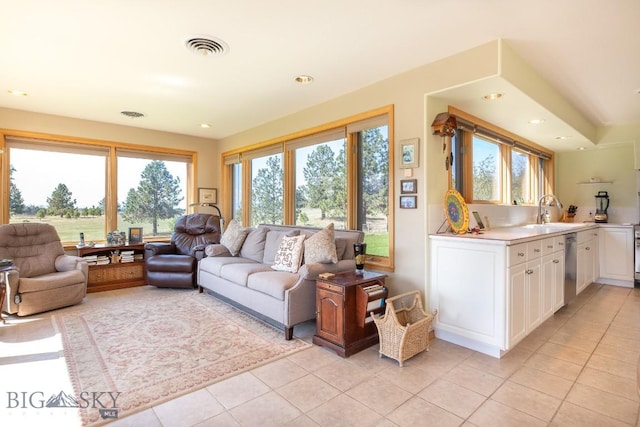 living area with light tile patterned floors, recessed lighting, and visible vents