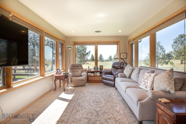 living area with light tile patterned floors, baseboards, and recessed lighting