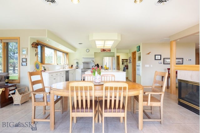 dining space with visible vents and light tile patterned floors