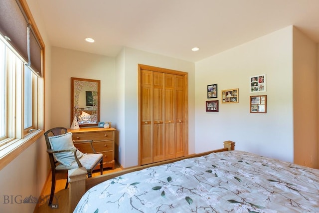 bedroom featuring a closet, recessed lighting, and wood finished floors