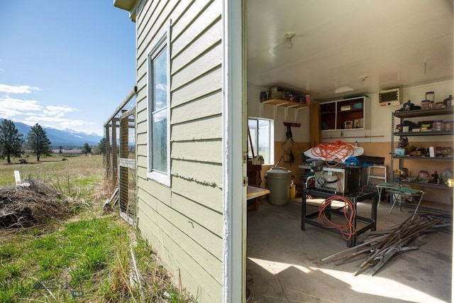 view of property exterior with a mountain view and a patio area