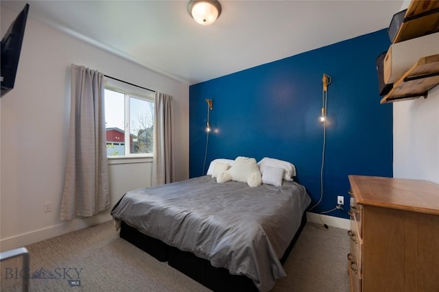 carpeted bedroom featuring baseboards