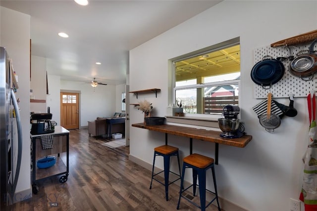 kitchen featuring dark wood-style flooring, stainless steel fridge with ice dispenser, wood counters, recessed lighting, and a ceiling fan