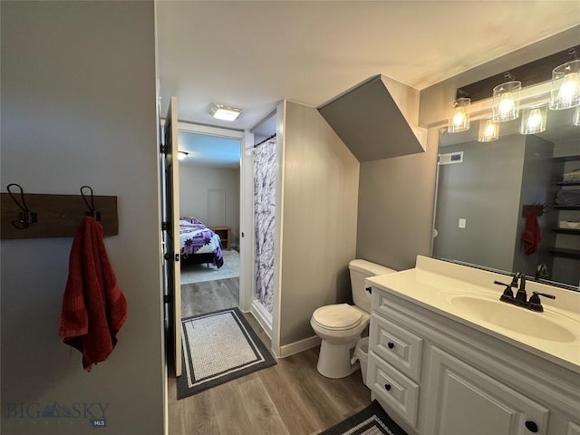 216 W 2nd Ave, Big Timber, MT 59011 - bathroom featuring vanity, toilet, baseboards, wood finished floors, and visible vents