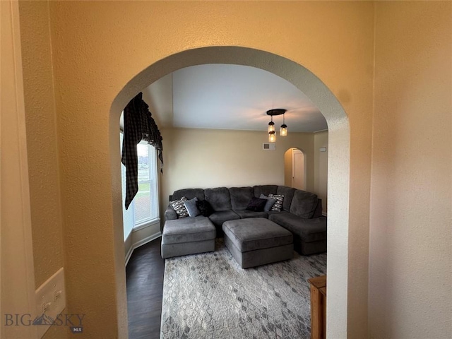 216 W 2nd Ave, Big Timber, MT 59011 - living area featuring visible vents, arched walkways, a textured wall, and wood finished floors