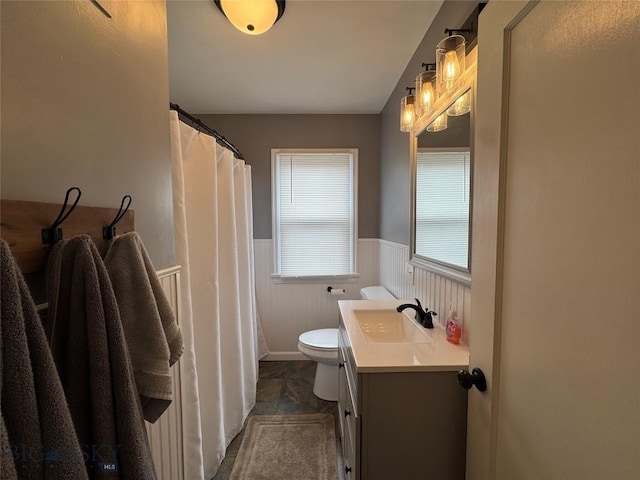 216 W 2nd Ave, Big Timber, MT 59011 - bathroom featuring vanity, wainscoting, and toilet