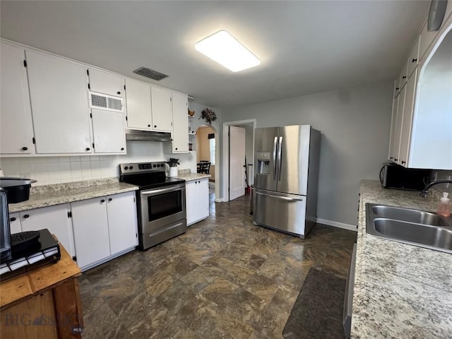 216 W 2nd Ave, Big Timber, MT 59011 - kitchen featuring visible vents, appliances with stainless steel finishes, a sink, light countertops, and under cabinet range hood