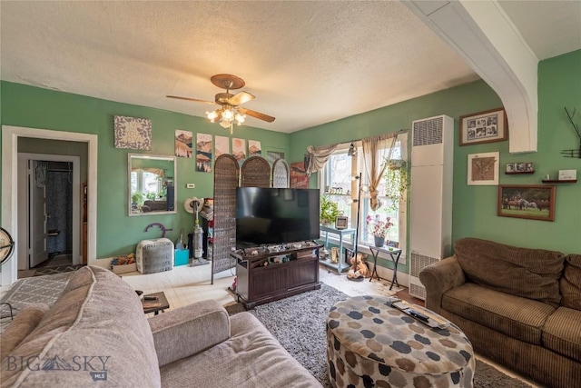 124 S M St, Livingston, MT 59047 - living room with a textured ceiling, a heating unit, and a ceiling fan