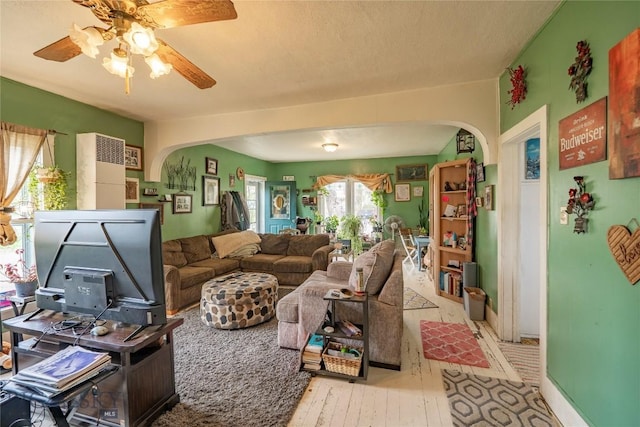 124 S M St, Livingston, MT 59047 - living room featuring arched walkways, ceiling fan, and hardwood / wood-style floors