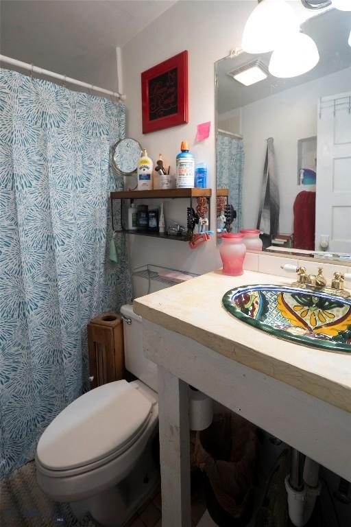 124 S M St, Livingston, MT 59047 - bathroom with vanity, toilet, and a shower with curtain