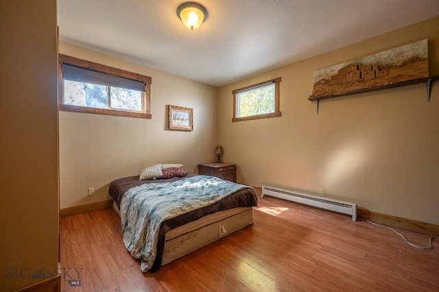 124 S M St, Livingston, MT 59047 - bedroom with baseboards, wood finished floors, and baseboard heating