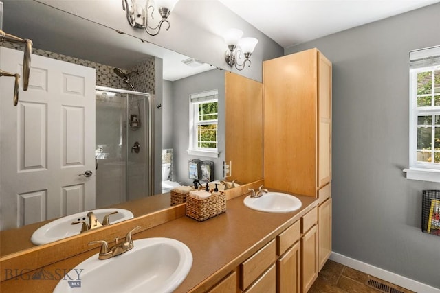 full bathroom featuring baseboards, a sink, and a shower stall