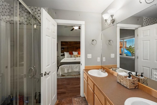 ensuite bathroom featuring a sink, ensuite bathroom, a ceiling fan, and a stall shower