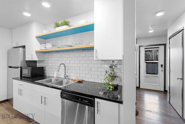kitchen featuring a sink, dark countertops, black microwave, and dishwasher