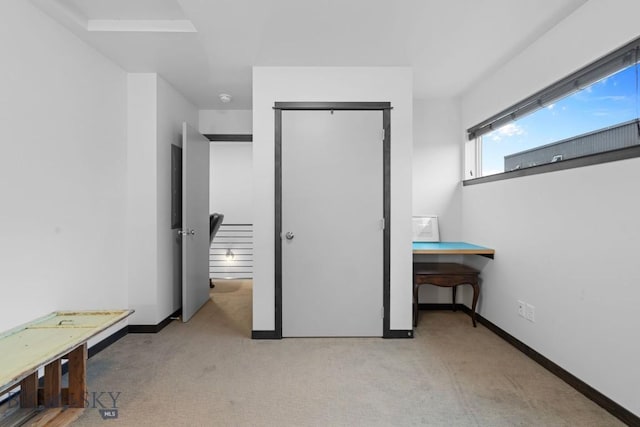 carpeted bedroom with baseboards and a closet
