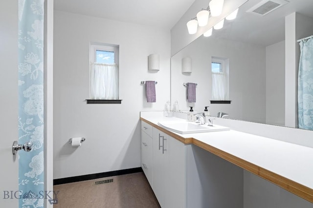 full bathroom with visible vents, baseboards, a wealth of natural light, and vanity