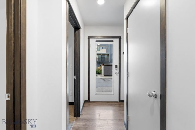 corridor with hardwood / wood-style flooring