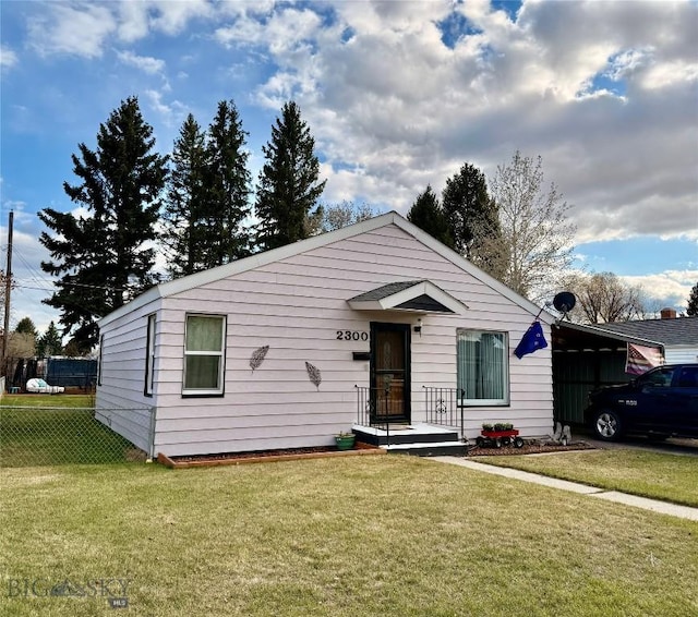 bungalow-style house featuring fence and a front yard