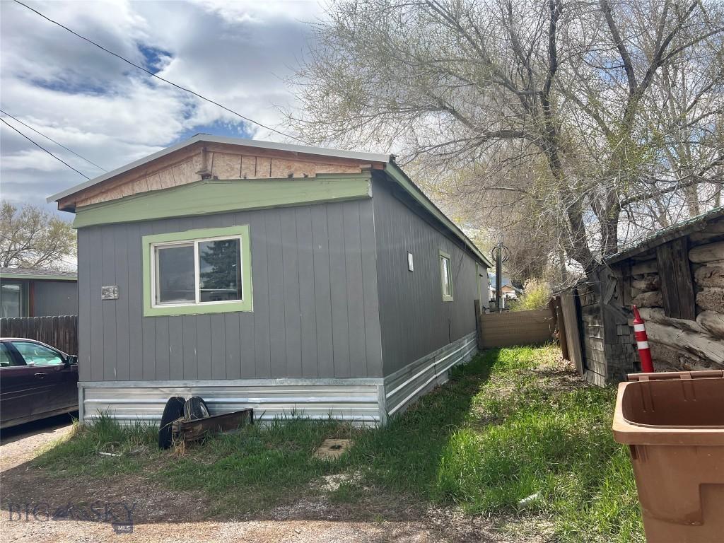 view of side of home featuring fence
