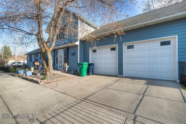 623 N Grand Ave, Bozeman, MT 59715 - view of property exterior featuring an attached garage and driveway