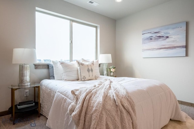 bedroom with baseboards, carpet flooring, and visible vents