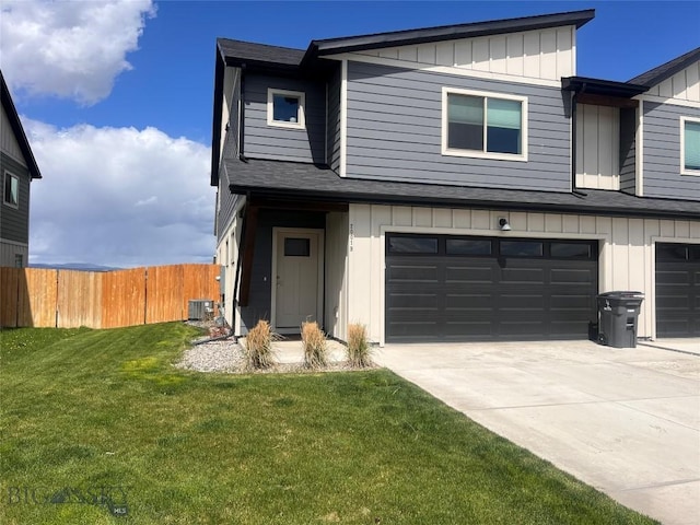 view of front of home with fence, board and batten siding, concrete driveway, and a garage
