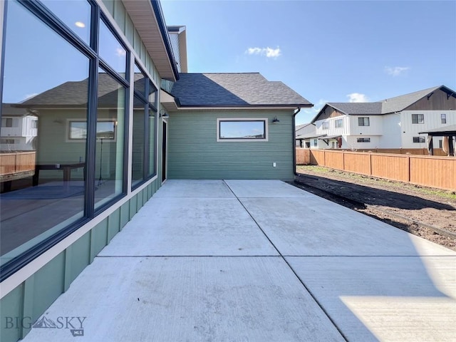 view of patio with fence and a residential view