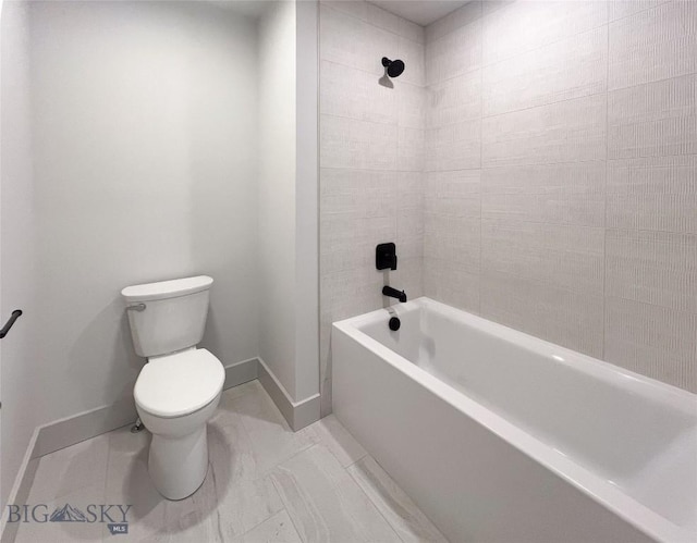full bath featuring baseboards, toilet, and shower / washtub combination