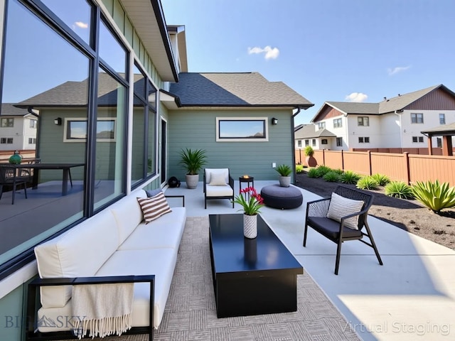 view of patio featuring fence, outdoor lounge area, and a residential view