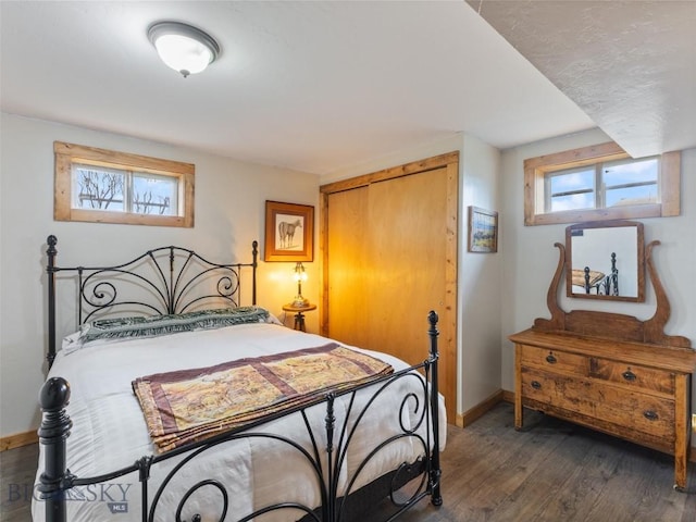 bedroom featuring wood-type flooring and baseboards