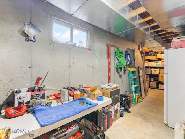 basement featuring freestanding refrigerator