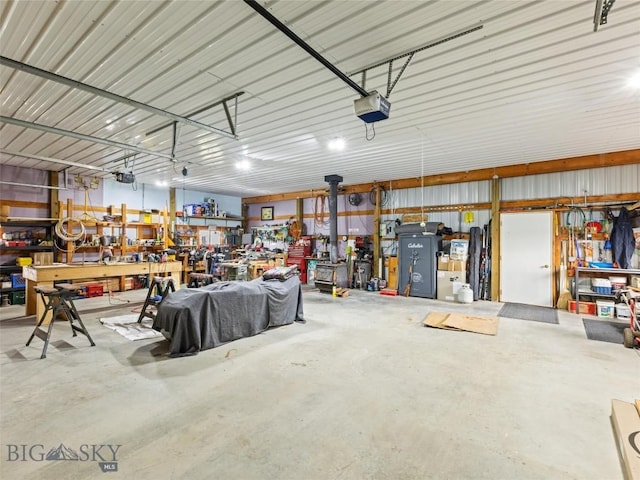 garage featuring a garage door opener and a workshop area