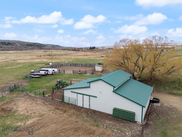 view of pole building featuring a rural view and fence