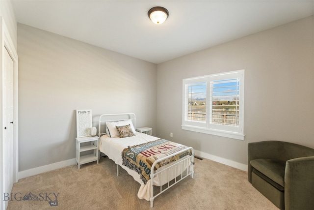 carpeted bedroom with baseboards